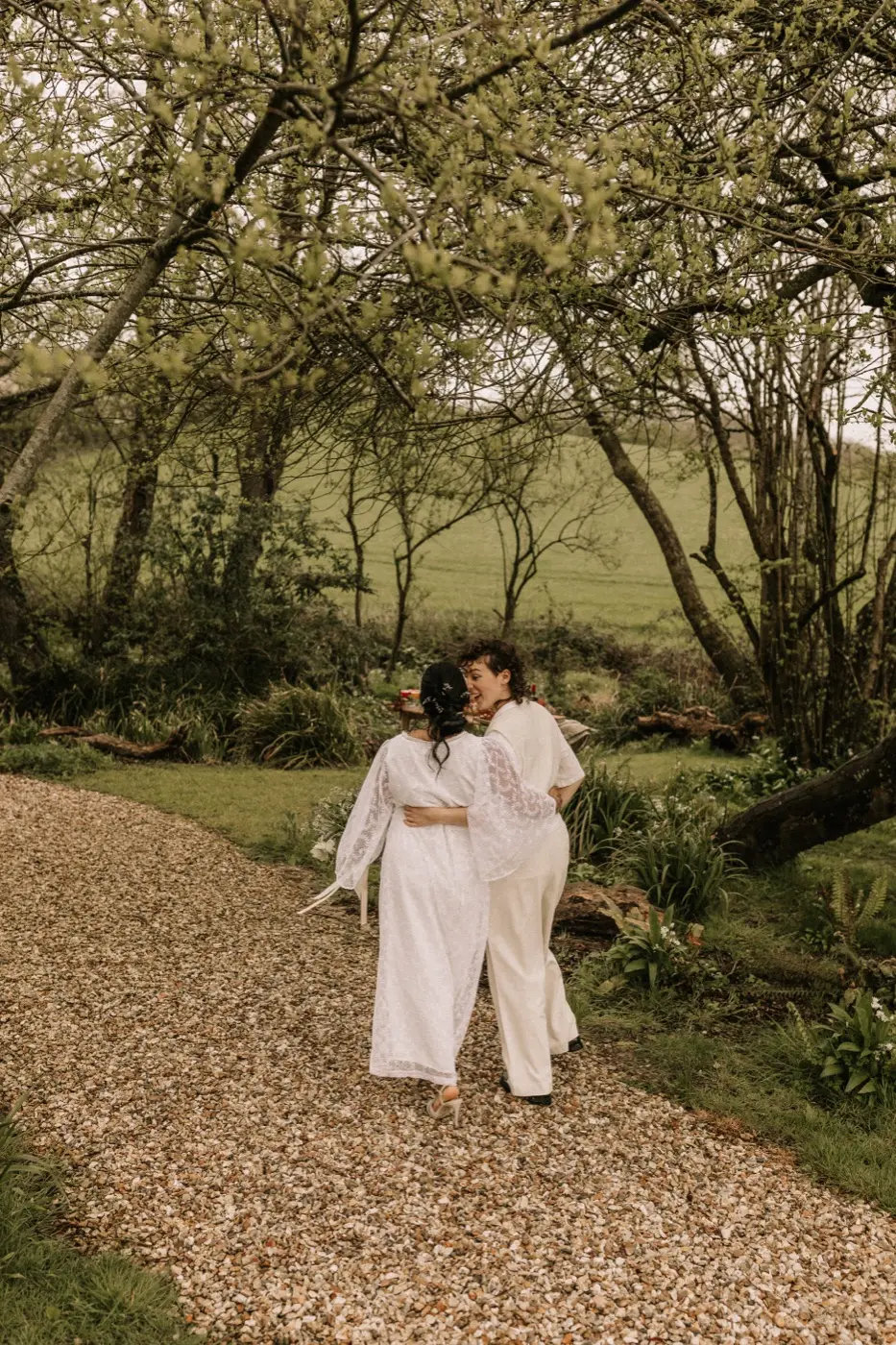 Nadia and Poppy walking the gravel path towards the oak arbour in the Woodland Sanctuary