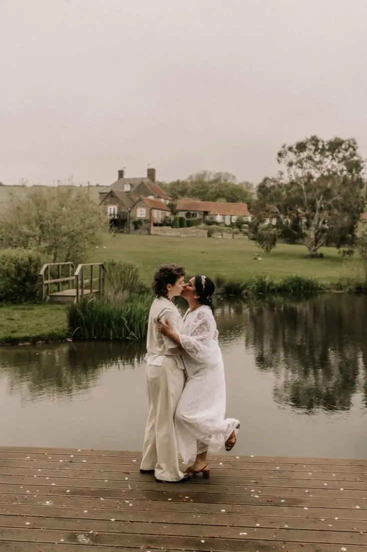 Nadia and Poppy embracing on the jetty by the lake
