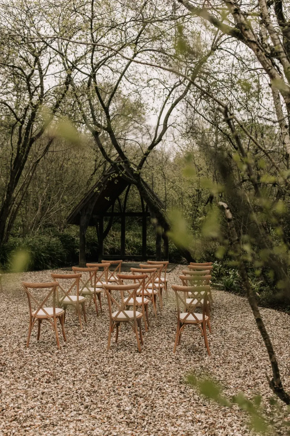 The Woodland Sanctuary ceremony space beneath a canopy of mature trees