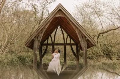 The oak arbour reflected in the still water