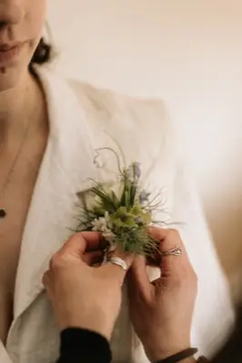 The corsage being pinned