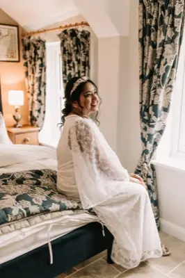 Sitting by the cottage window in the wedding dress