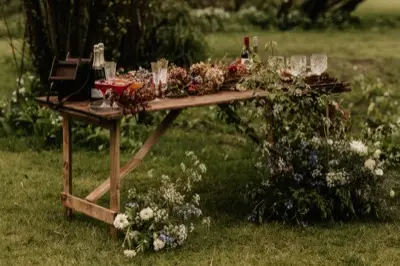 The drinks table being set in the woodland