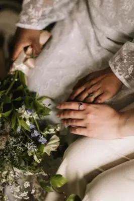 Flowers held against the lace dress