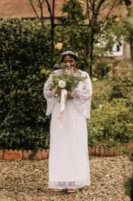 Full-length portrait with the bouquet in the cottage garden