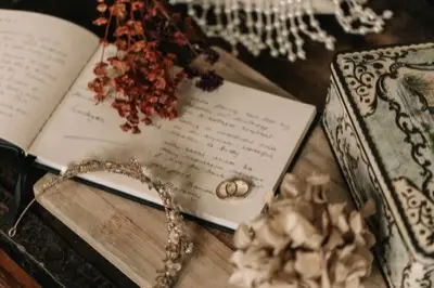 Two gold rings resting on a handwritten guest book page