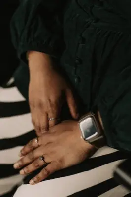 A close-up of hands and rings