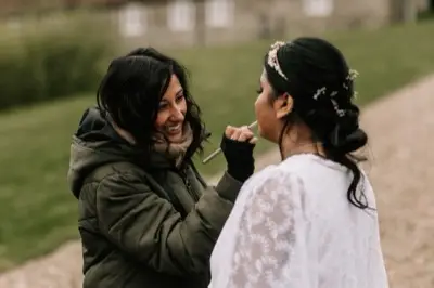 Laughing during a lipstick touch-up