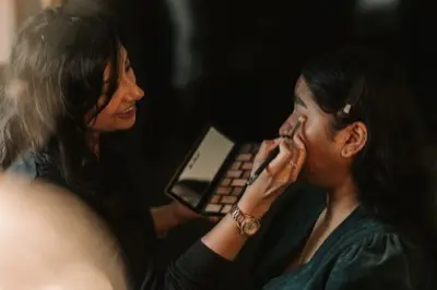 Nipona applying makeup, reflected in the mirror