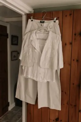 The wedding outfits hanging on the cottage wardrobe