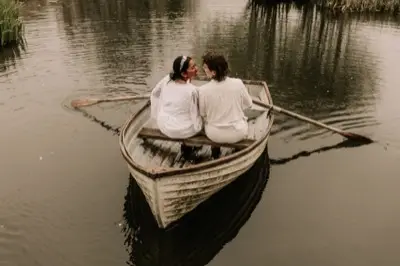 Rowing the small wooden boat across the lake