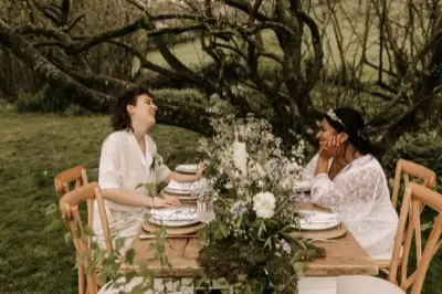 Nadia and Poppy laughing at the woodland table